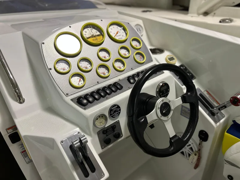 Slide: The Image of 2005 Baja 30 Outlaw boat dashboard with gauges and steering wheel. - 12