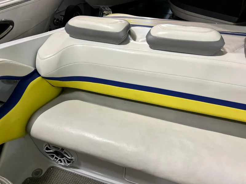 Slide: The Image of 2005 Baja 30 Outlaw boat interior with white, yellow, and blue seating. - 13