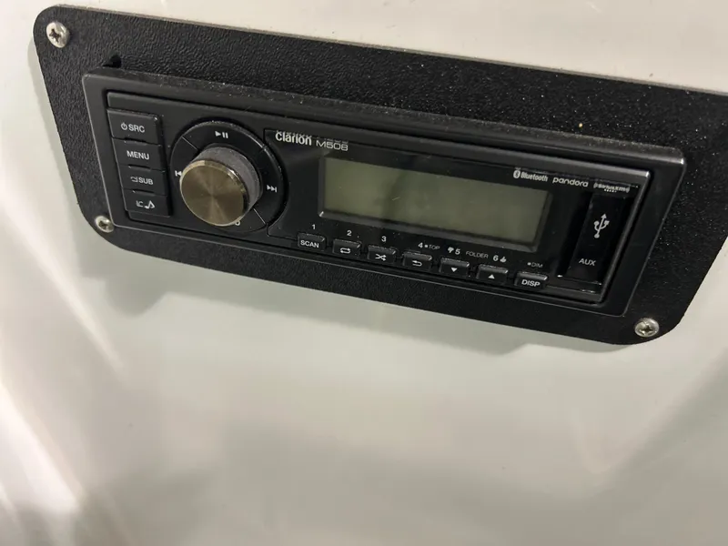 Slide: The Image of Clarion stereo system in a 2005 Baja 30 Outlaw boat dashboard. - 17