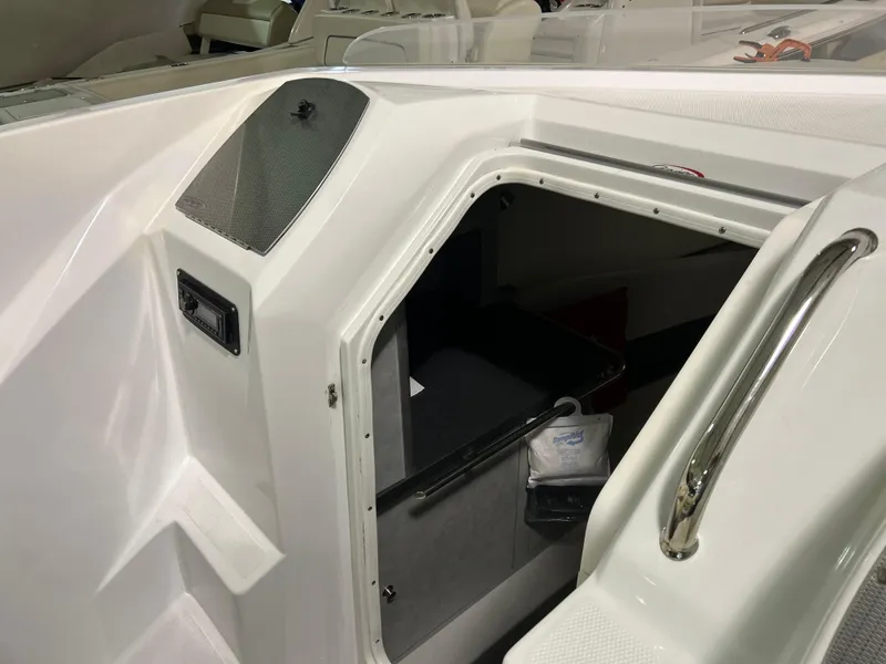 Slide: The Image of 2005 Baja 30 Outlaw boat cabin entrance with sleek white interior and stainless steel handle. - 19