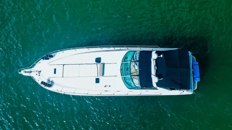 Slide: The Image of Aerial view of 1994 Sea Ray 500 Sundancer yacht on green water. - 12
