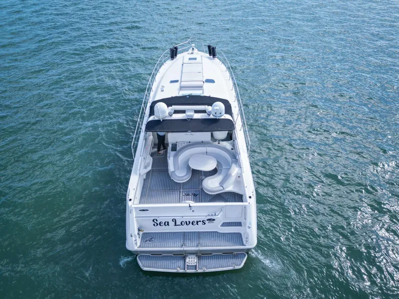 Slide: The Image of 1994 Sea Ray 500 Sundancer yacht named "Sea Lovers" cruising on open water. - 13