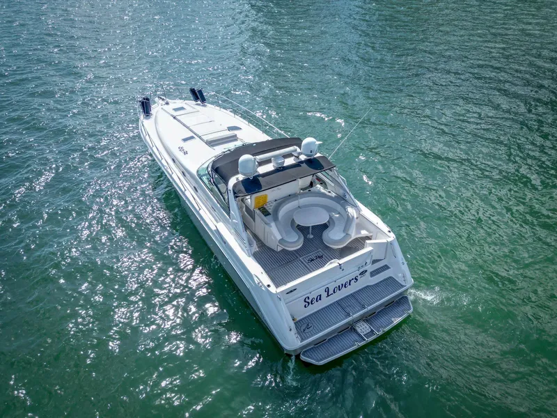 Slide: The Image of 1994 Sea Ray 500 Sundancer yacht cruising on clear blue water. - 15