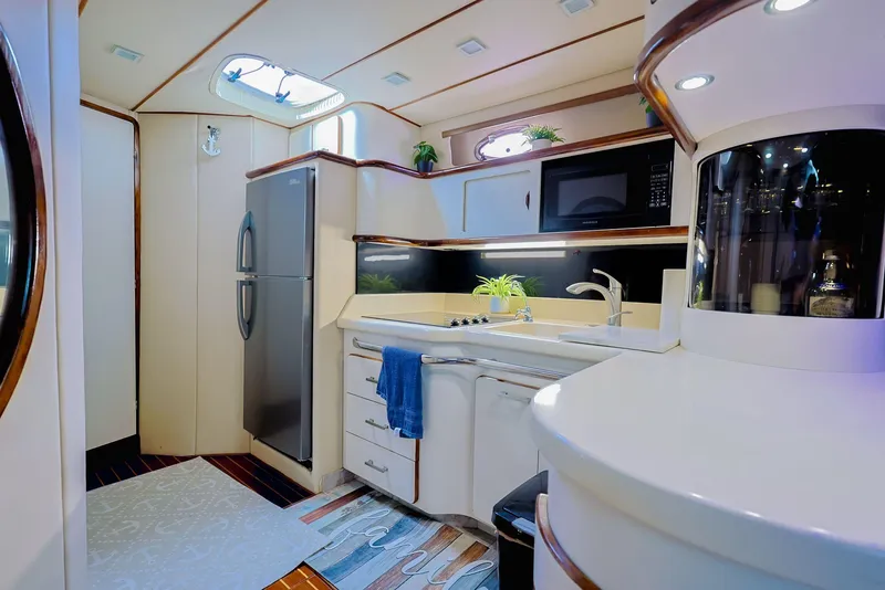 Slide: The Image of Luxurious 1994 Sea Ray 500 Sundancer yacht kitchen with modern appliances and elegant design. - 17