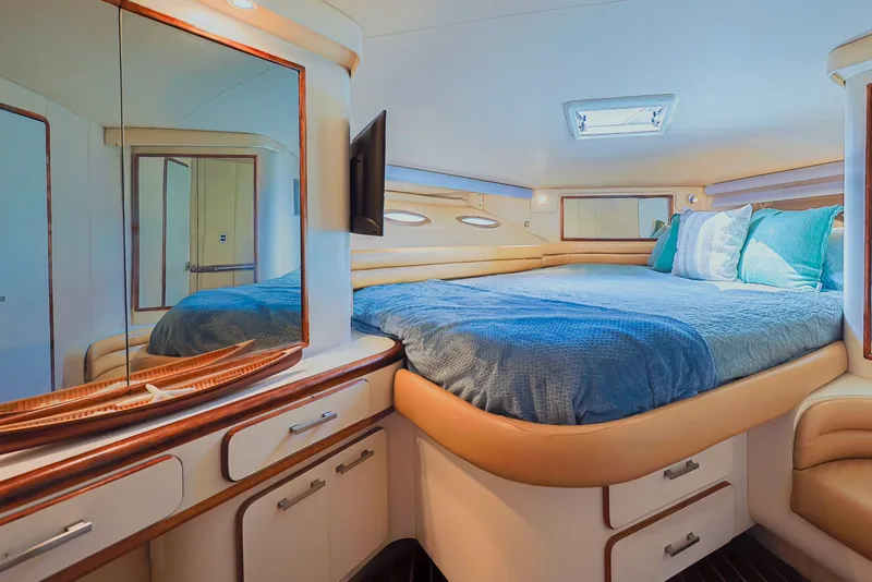Slide: The Image of Luxurious cabin interior of 1994 Sea Ray 500 Sundancer yacht with cozy bed and elegant decor. - 19