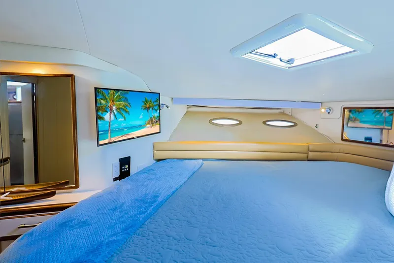 Slide: The Image of Luxurious 1994 Sea Ray 500 Sundancer cabin with cozy bed and scenic TV display. - 20