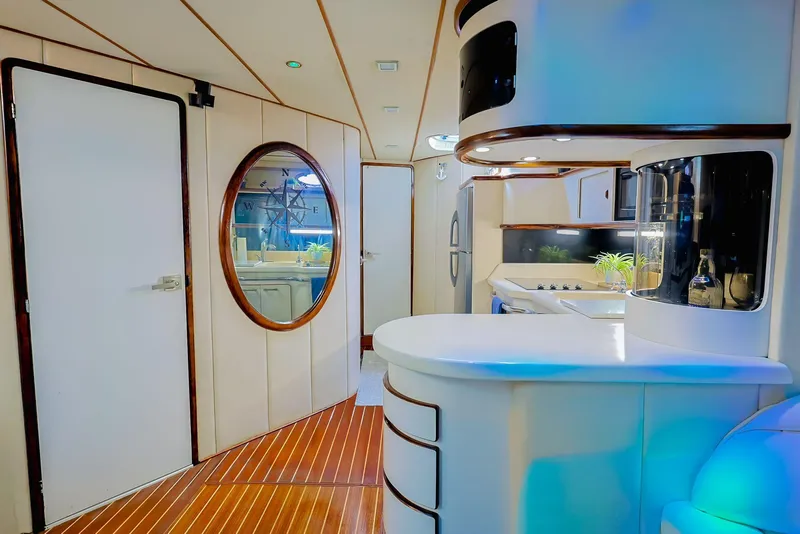 Slide: The Image of Luxurious interior of 1994 Sea Ray 500 Sundancer yacht with modern kitchen and wood flooring. - 24