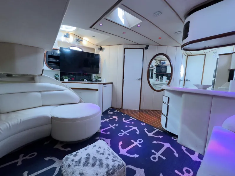 Slide: The Image of Luxurious interior of 1994 Sea Ray 500 Sundancer yacht with modern decor and anchor-themed carpet. - 28
