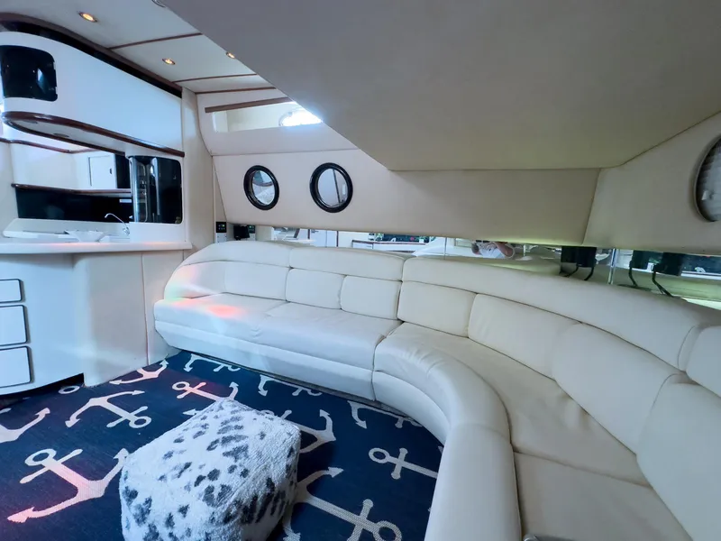Slide: The Image of Luxurious interior of 1994 Sea Ray 500 Sundancer with white leather seating and nautical decor. - 34