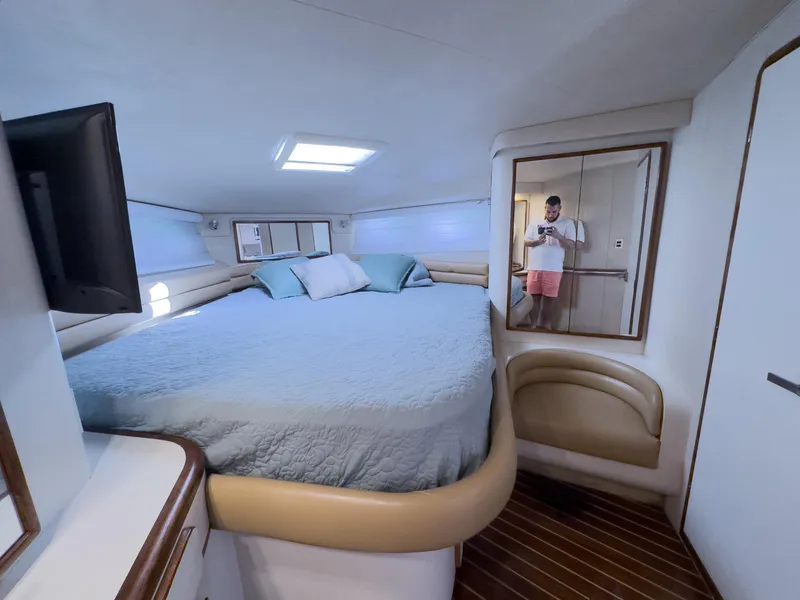 Slide: The Image of Luxurious cabin interior of 1994 Sea Ray 500 Sundancer yacht with cozy bed and modern amenities. - 35