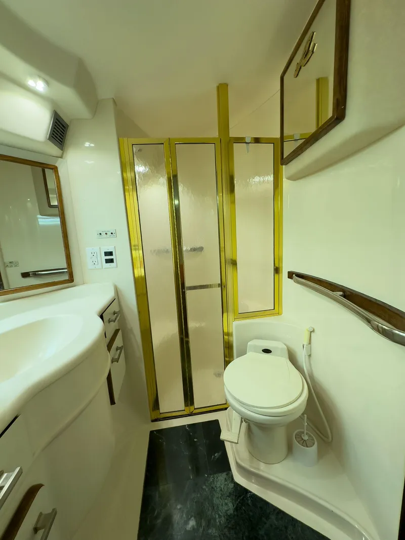 Slide: The Image of Luxurious bathroom in 1994 Sea Ray 500 Sundancer yacht with gold accents and modern fixtures. - 37
