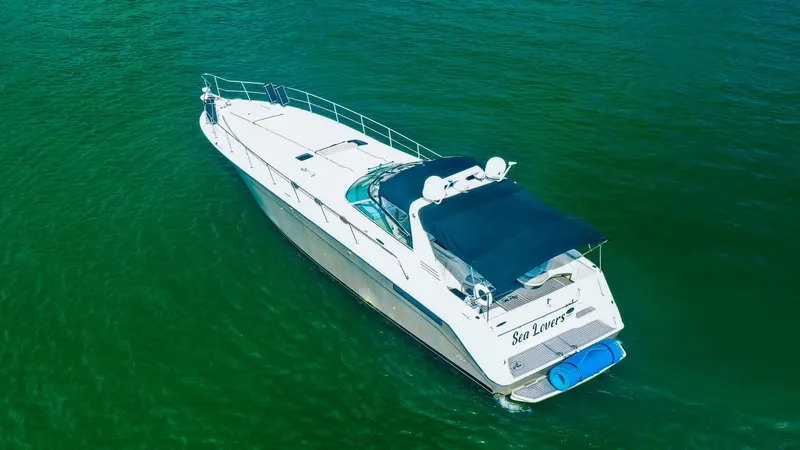 Slide: The Image of 1994 Sea Ray 500 Sundancer yacht cruising on green water. - 6