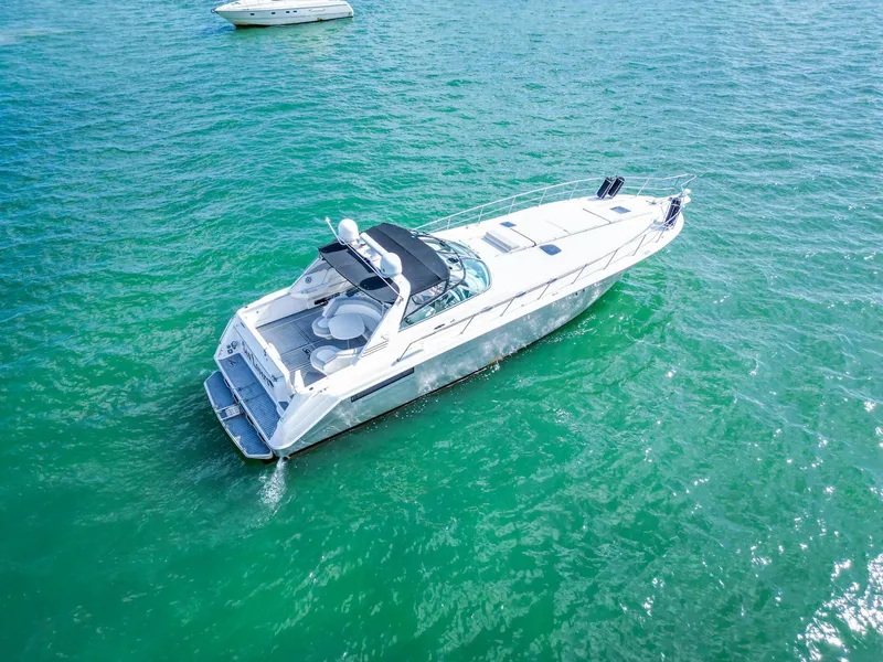 Slide: The Image of 1994 Sea Ray 500 Sundancer yacht cruising on clear turquoise waters. - 7