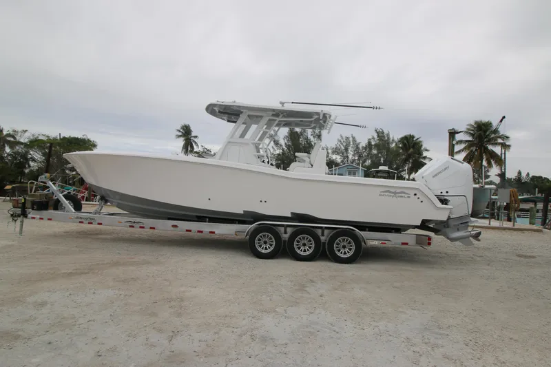 Slide: The Image of 2025 Invincible 33 Open Fisherman boat on a trailer, parked outdoors. - 11