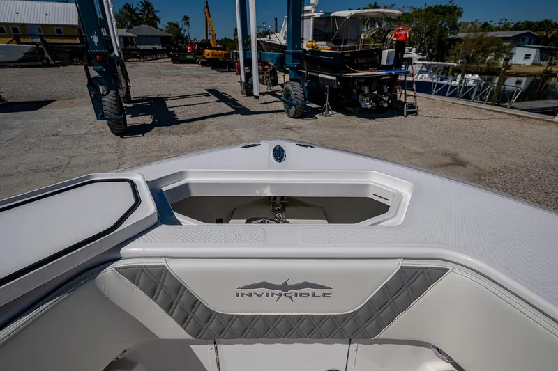 Slide: The Image of 2025 Invincible 33 Open Fisherman boat, bow view, docked at a marina. - 18