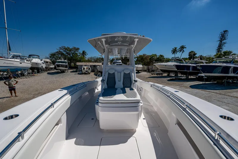 Slide: The Image of 2025 Invincible 33 Open Fisherman boat docked under clear blue sky. - 19