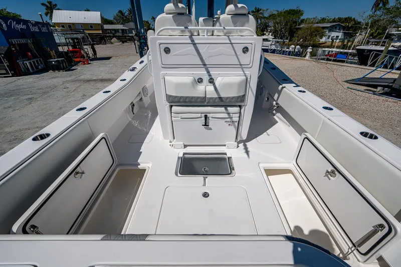 Slide: The Image of 2025 Invincible 33 Open Fisherman boat interior with storage compartments and seating. - 24