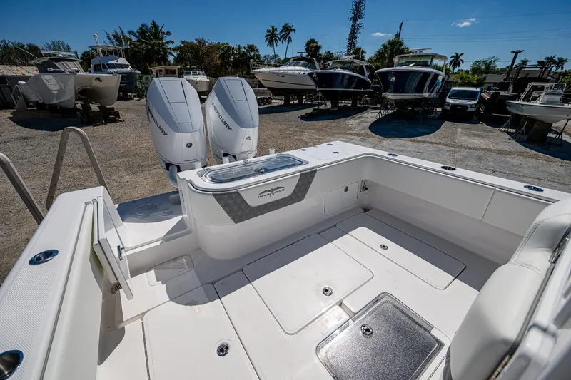 Slide: The Image of 2025 Invincible 33 Open Fisherman boat with dual engines, docked under a clear blue sky. - 27