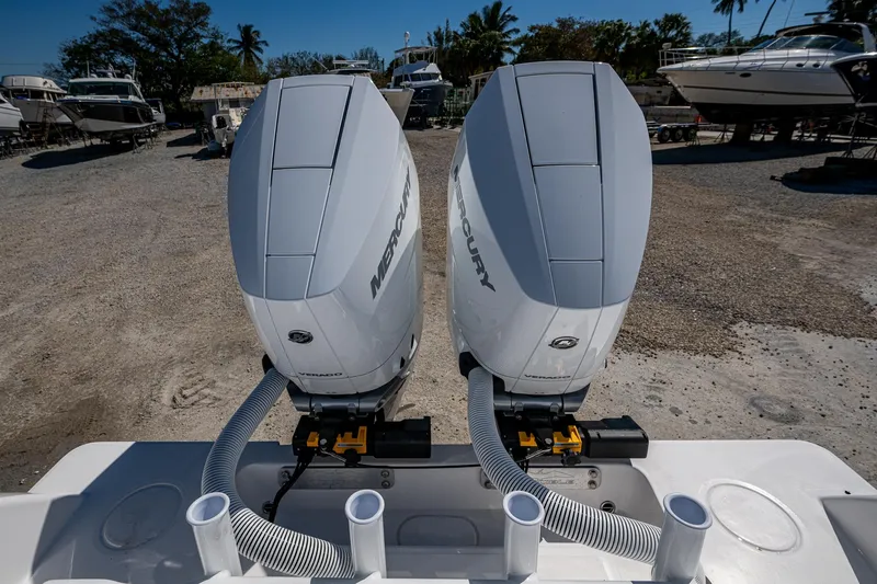 Slide: The Image of 2025 Invincible 33 Open Fisherman with dual Mercury outboard engines in a boatyard. - 30