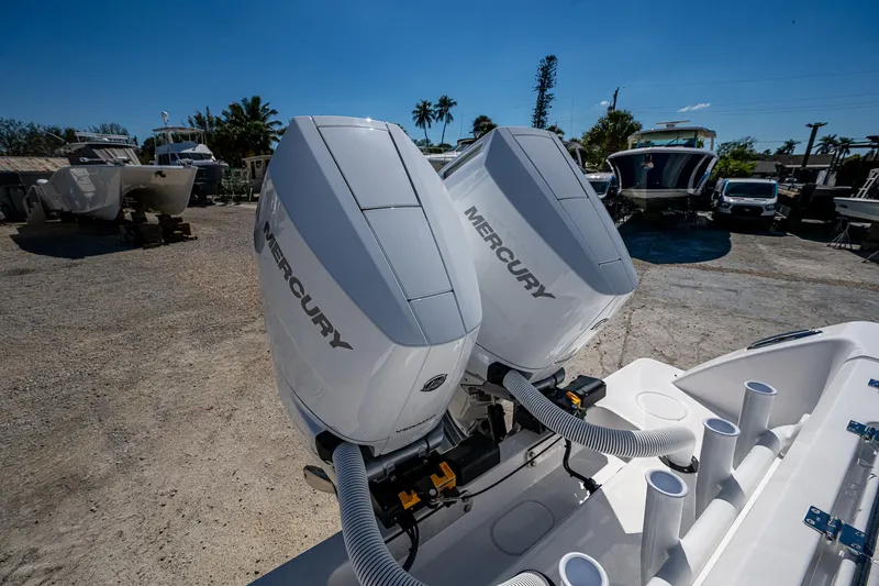 Slide: The Image of 2025 Invincible 33 Open Fisherman with dual Mercury outboard engines in a sunny marina. - 31