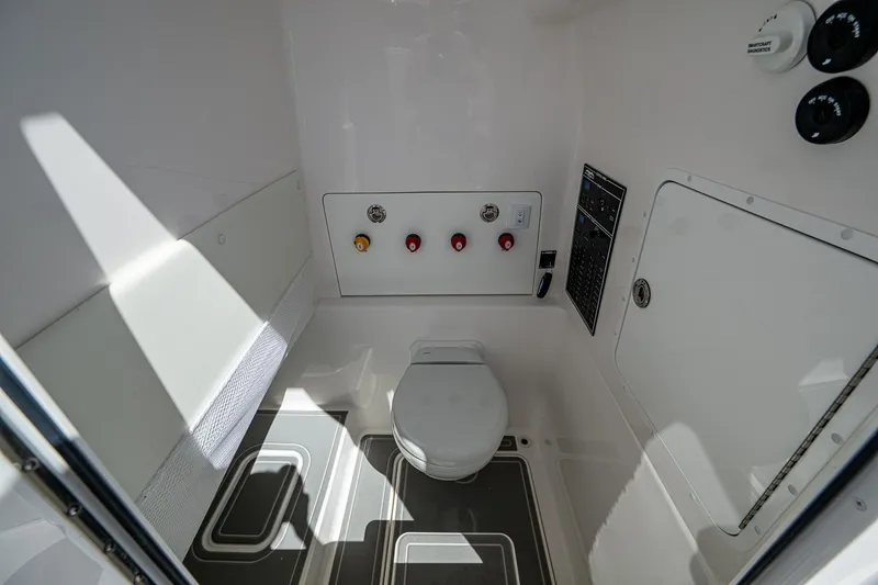 Slide: The Image of 2025 Invincible 33 Open Fisherman boat interior with modern marine toilet and control panel. - 33