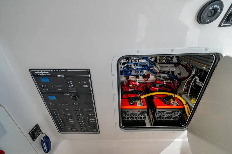Slide: The Image of Electrical panel and battery compartment of 2025 Invincible 33 Open Fisherman boat. - 35
