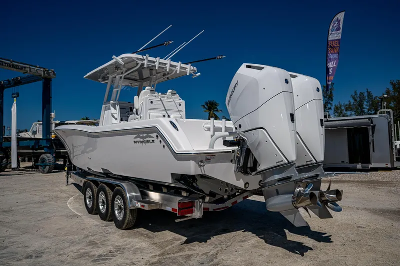 Slide: The Image of 2025 Invincible 33 Open Fisherman boat on trailer, featuring dual outboard engines. - 45