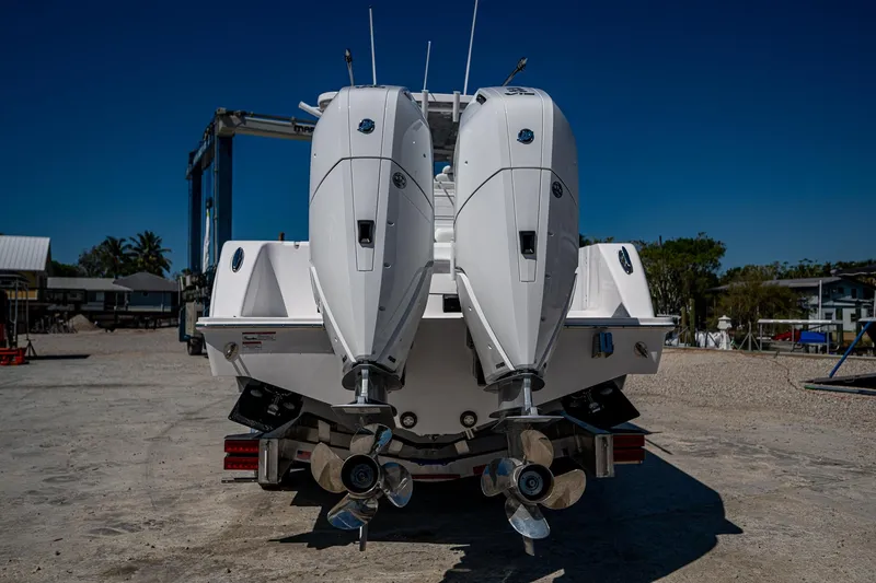 Slide: The Image of 2025 Invincible 33 Open Fisherman boat with dual outboard motors, rear view. - 46