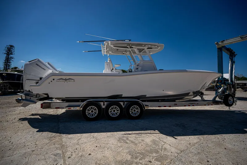 Slide: The Image of 2025 Invincible 33 Open Fisherman boat on trailer under clear blue sky. - 48