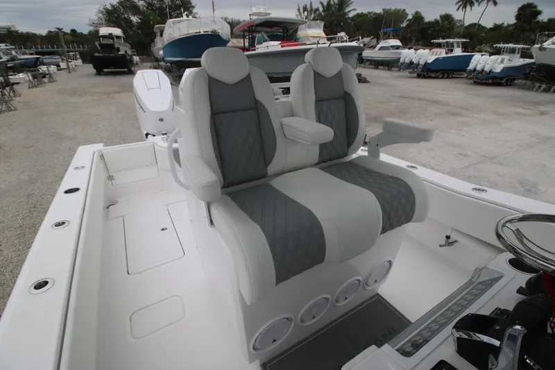 Slide: The Image of 2025 Invincible 33 Open Fisherman boat with dual seats in a marina setting. - 6