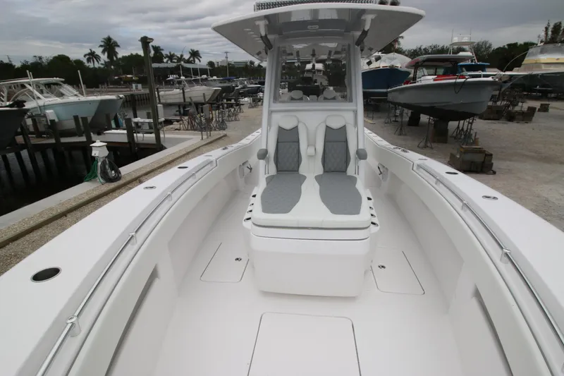 Slide: The Image of 2025 Invincible 33 Open Fisherman boat at a marina, showcasing spacious deck and seating. - 7