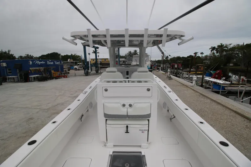 Slide: The Image of 2025 Invincible 33 Open Fisherman boat, spacious deck, modern design, docked at marina. - 9