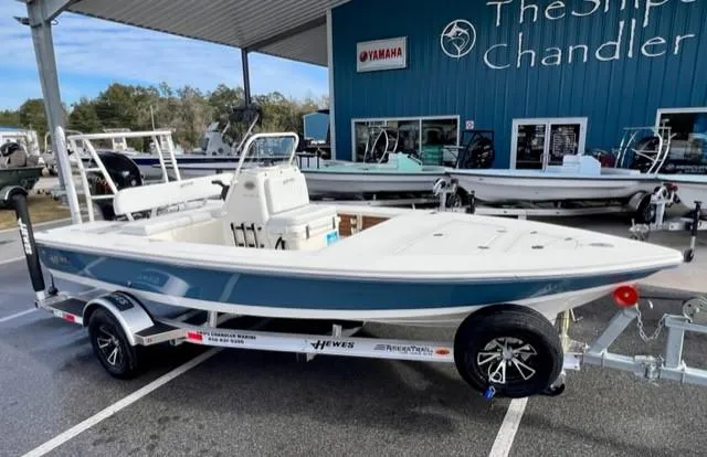 Slide: The Image of 2026 Hewes Redfisher 18 boat console with steering wheel and rod holders. - 2