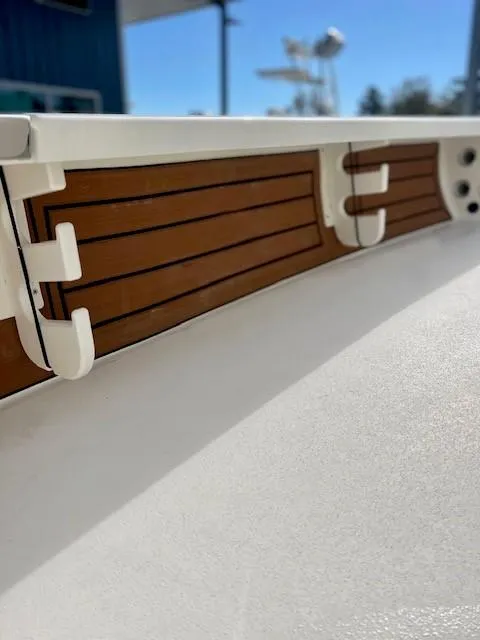 Slide: The Image of 2026 Hewes Redfisher 18 boat interior with rod holders and sleek design. - 8