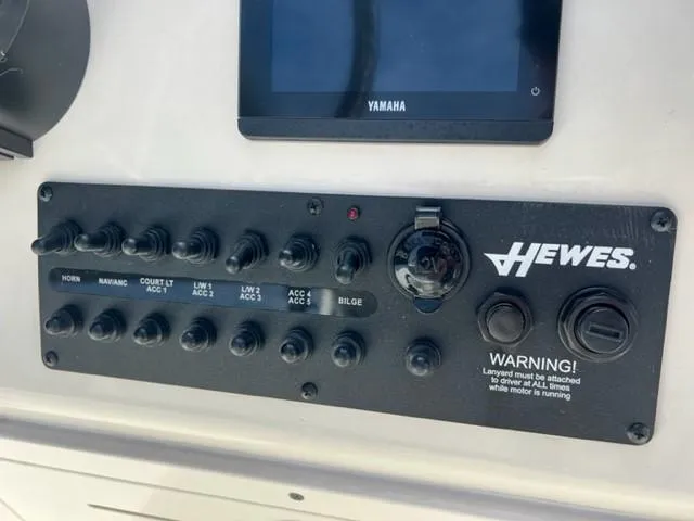 Slide: The Image of Open storage compartment on 2026 Hewes Redfisher 18 boat, featuring sleek design. - 9