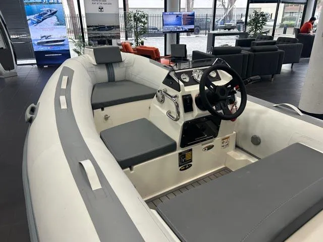 Slide: The Image of 2021 Northstar Axis 3.1 inflatable boat interior with steering console and seating. - 5