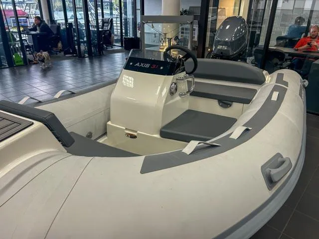 Slide: The Image of 2021 Northstar Axis 3.1 inflatable boat displayed indoors, featuring a sleek design and modern controls. - 7