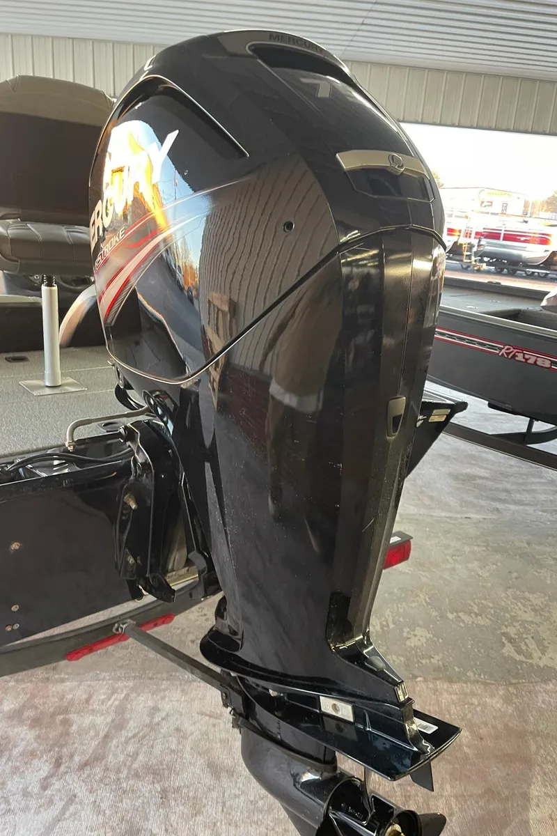 Slide: The Image of 2018 Tracker Pro Team 175TXW boat motor, sleek black design in showroom. - 3