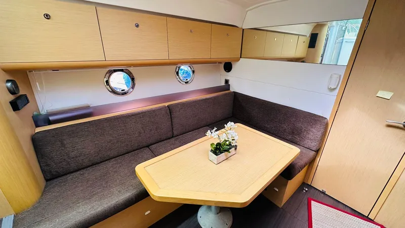 Slide: The Image of Interior of 2013 Beneteau GRAN TURISMO yacht with cozy seating and wooden table. - 11