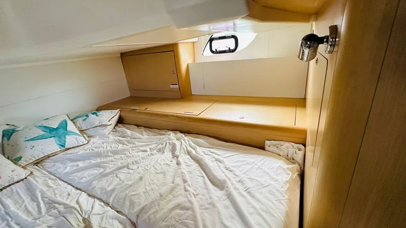 Slide: The Image of Cozy cabin interior of 2013 Beneteau Gran Turismo yacht with bed and window. - 14