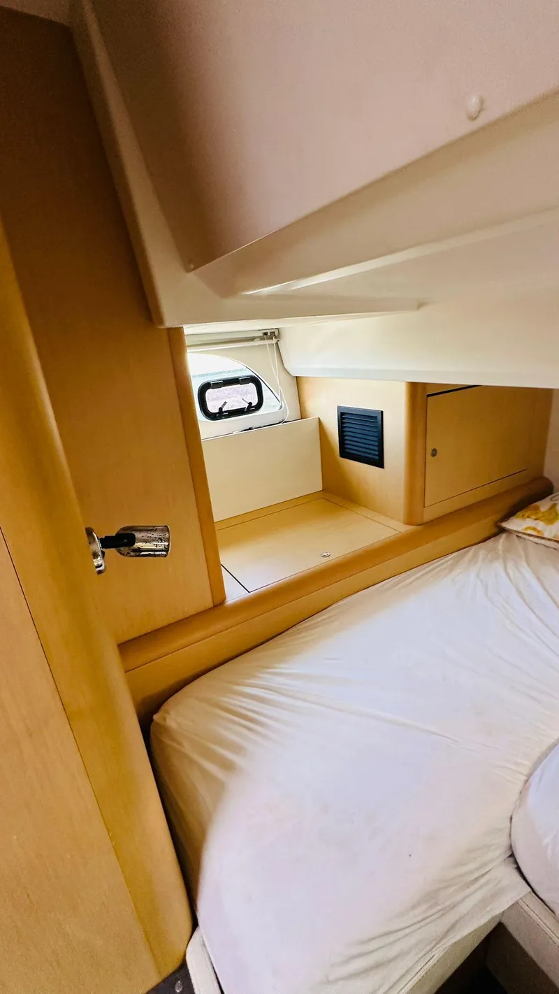 Slide: The Image of 2013 Beneteau Gran Turismo cabin interior with bed and window. - 15