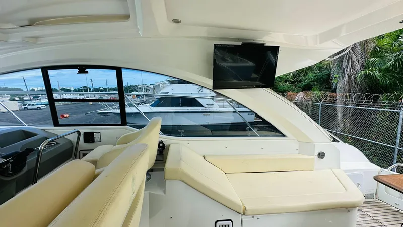 Slide: The Image of Interior of 2013 Beneteau GRAN TURISMO yacht with beige seating and a mounted TV. - 17