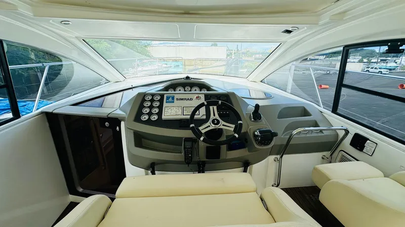 Slide: The Image of 2013 Beneteau Gran Turismo yacht cockpit with modern steering and navigation controls. - 9