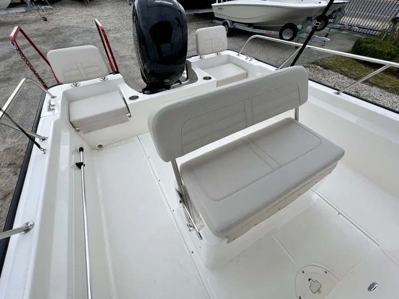 Slide: The Image of 2025 Boston Whaler 190 Montauk boat interior with seating and motor. - 11