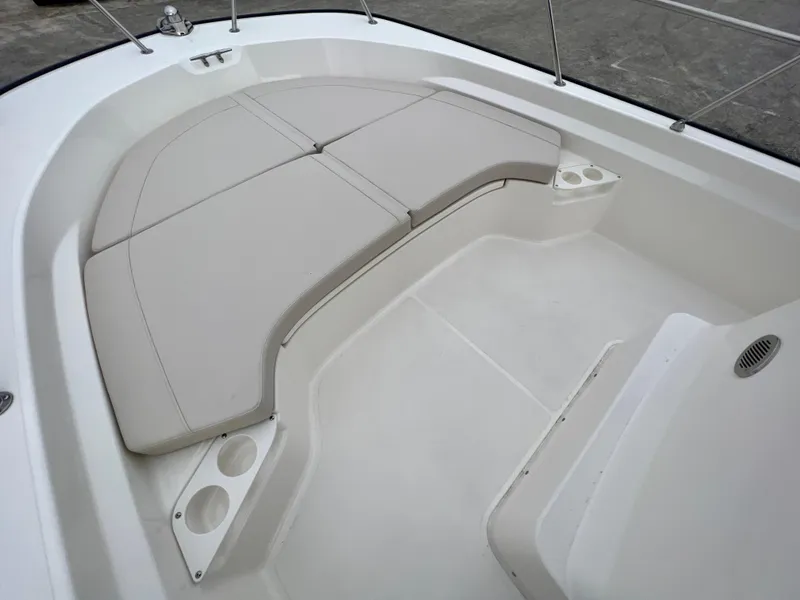 Slide: The Image of 2025 Boston Whaler 190 Montauk boat interior with cushioned seating and cup holders. - 12