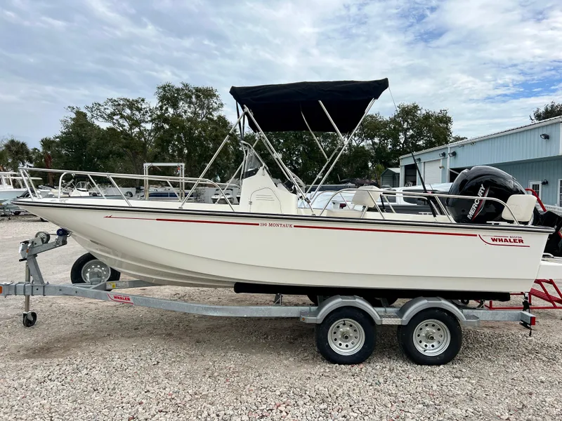 Slide: The Image of 2025 Boston Whaler 190 Montauk boat on trailer, outdoor setting. - 5