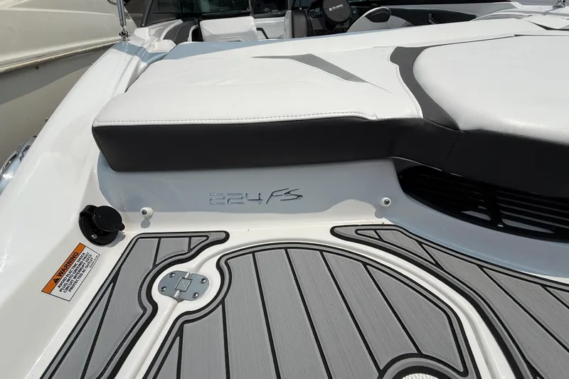 Slide: The Image of 2025 Monterey 224FS boat interior with cushioned seating and sleek design. - 13