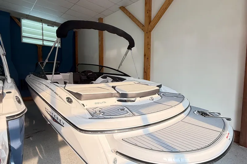 Slide: The Image of 2025 Monterey 224FS boat in showroom, featuring sleek design and modern amenities. - 2