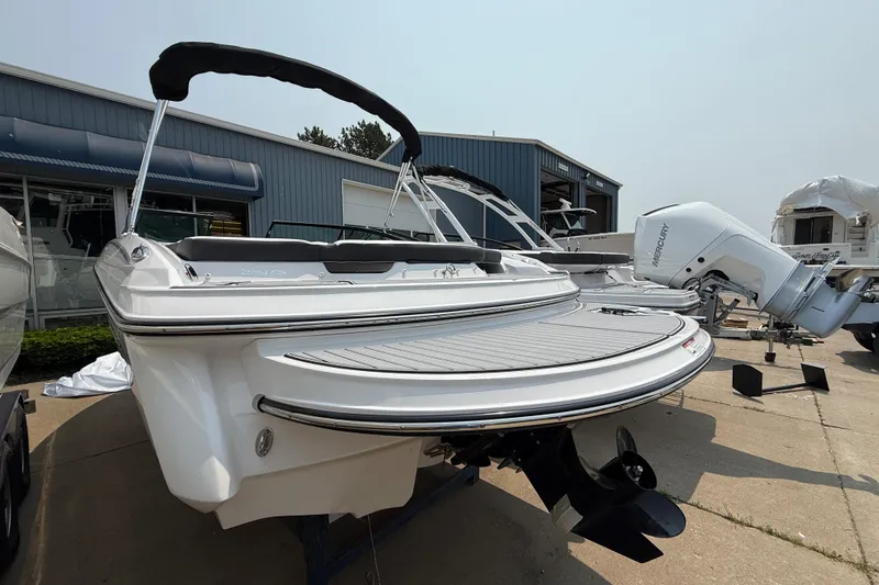 Slide: The Image of 2025 Monterey 224FS boat with Mercury engine, displayed outdoors near a showroom. - 3