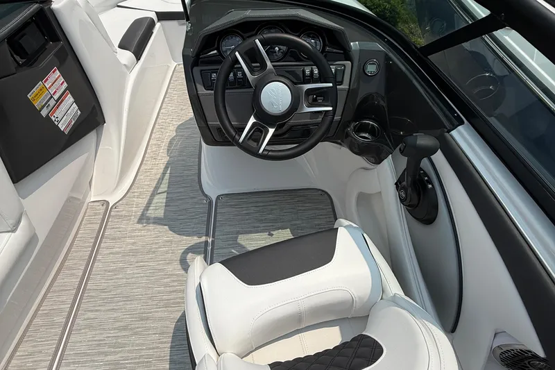 Slide: The Image of Interior view of 2025 Monterey 224FS boat, featuring sleek steering and modern controls. - 4